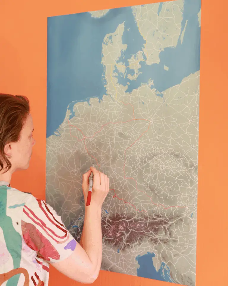 Lucy tracing our journeys on the first 60x90 test print map